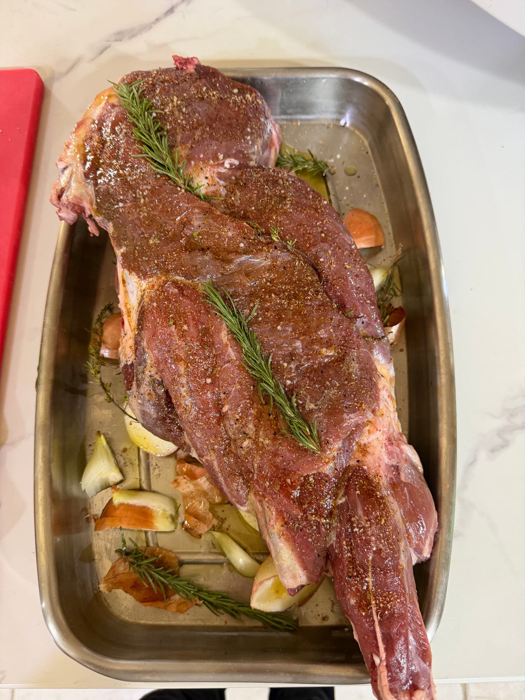 Raw roast rubbed with herbs and rosemary before cooking