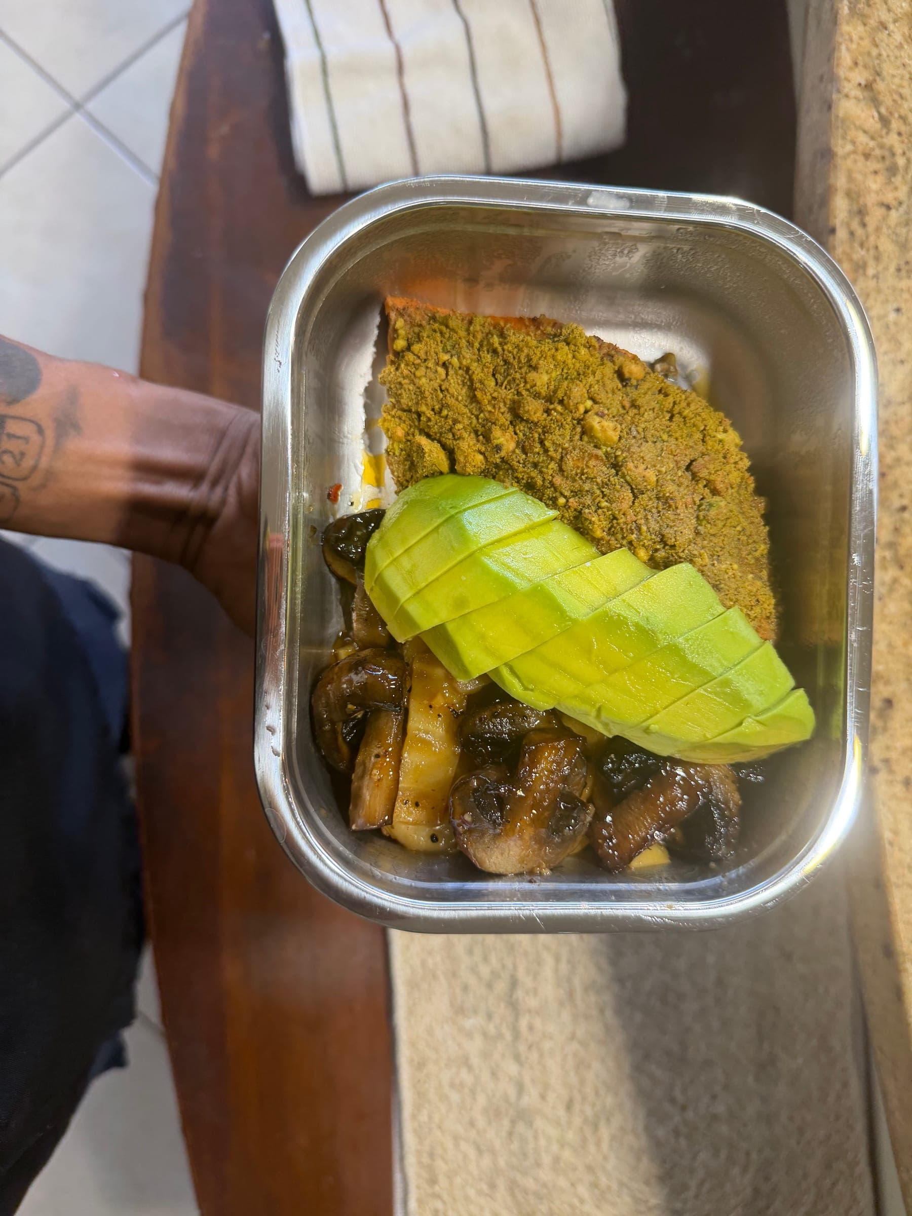 Meal-prep container with fish, avocado and roasted vegetables