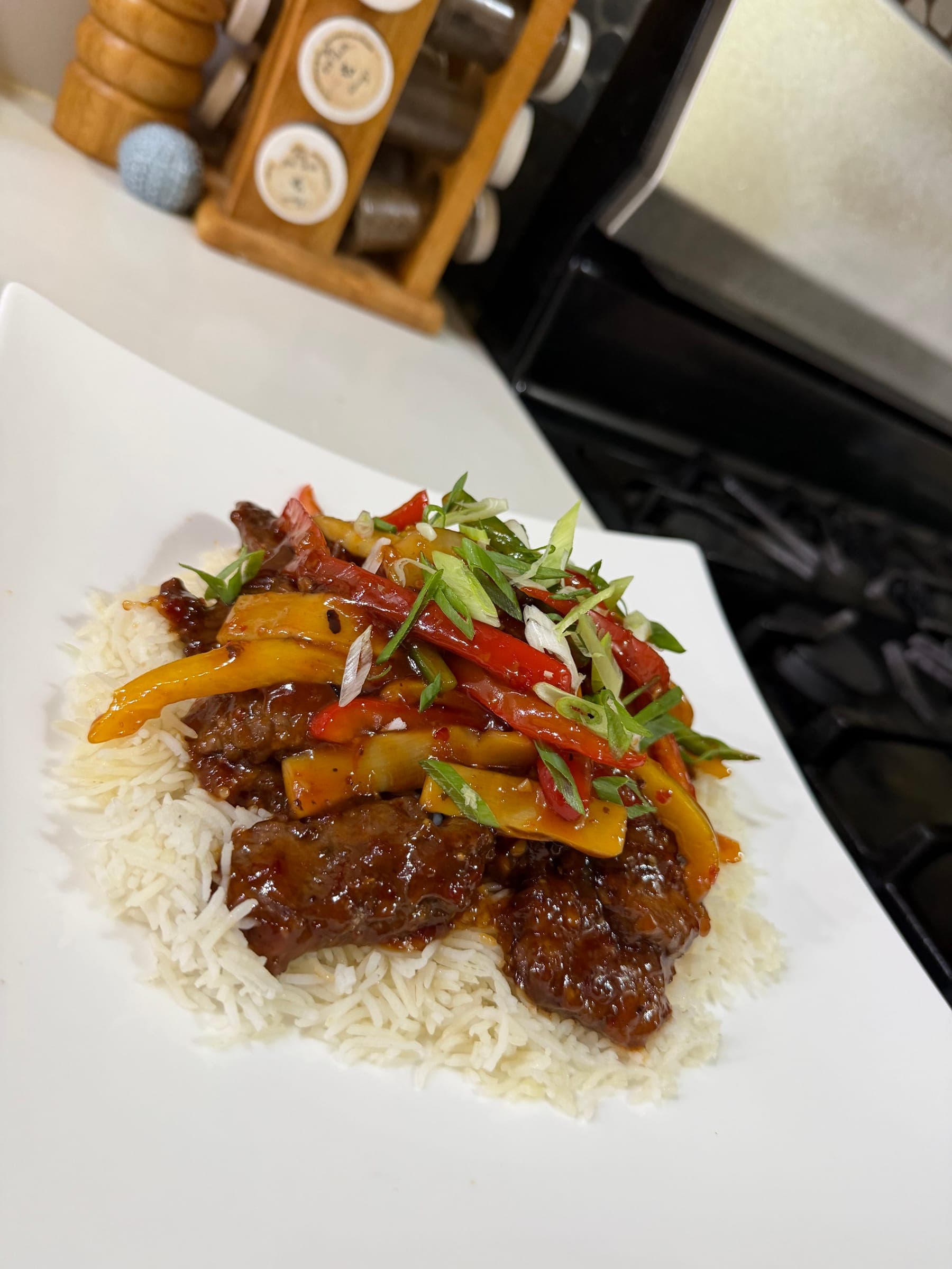 Pepper steak with colourful peppers over white rice