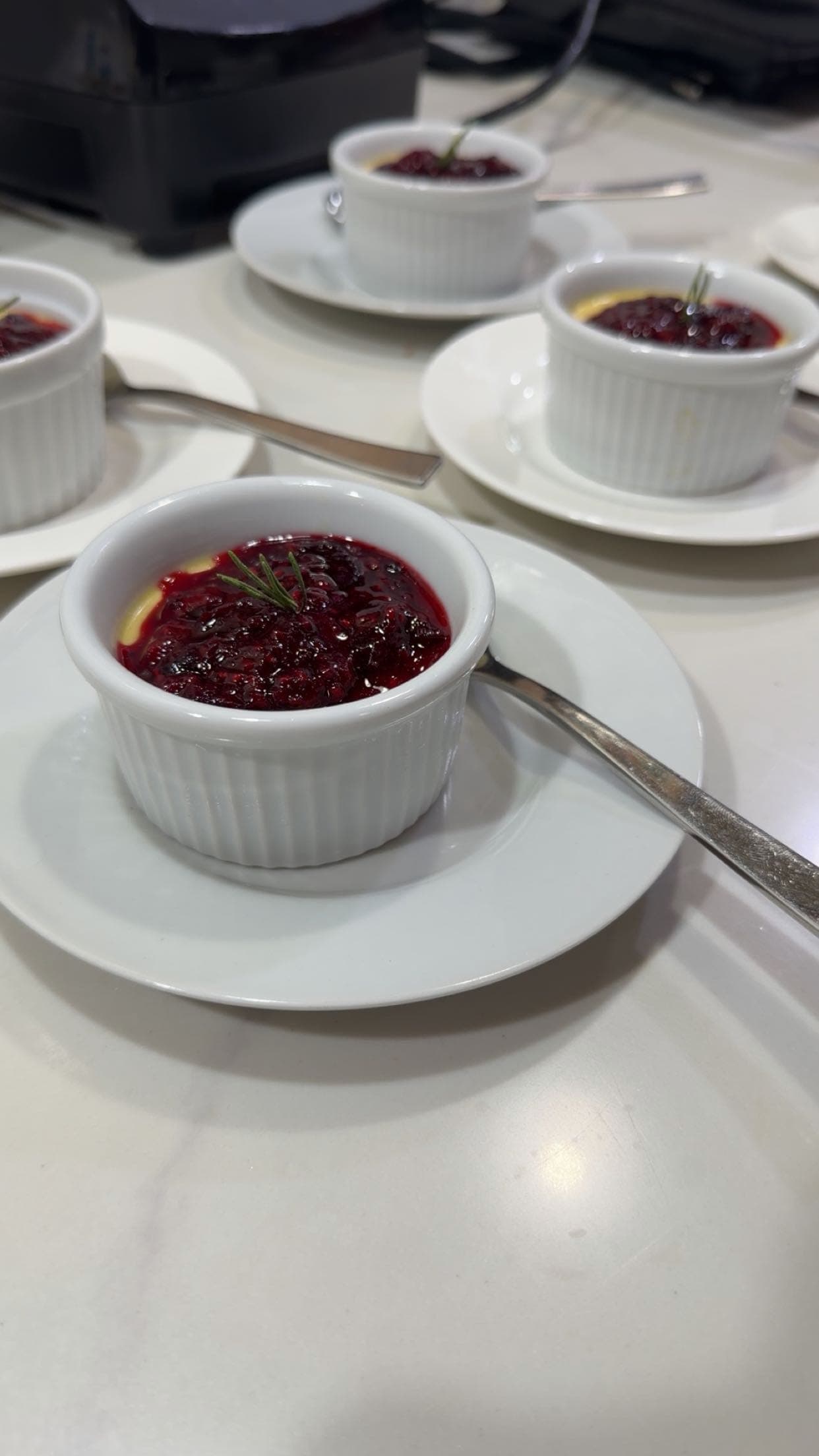 Ramekins of deep red dessert on saucers