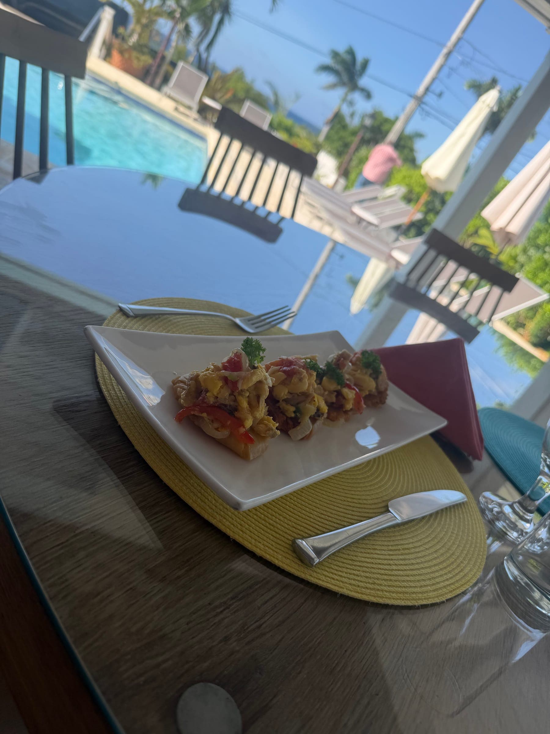 Plated dish on a villa table beside the pool